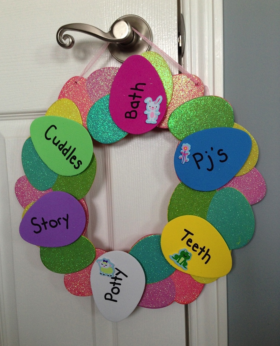 Easter egg hunt - image is a homemade egg wreath on a door in all colours of eggs like pink, blue, bright green and yellow