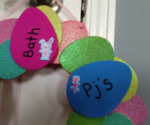 Easter egg hunt - close up of the wreath with  a sticker on an egg that says bath and another that says pjs
