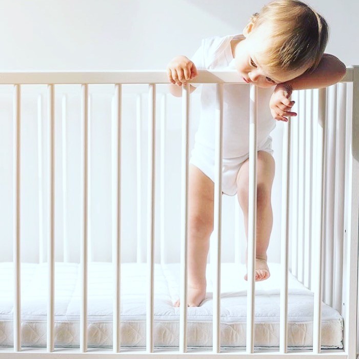 child standing in crib