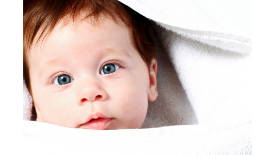Baby in towel after a bath - @gnss_jamie shares tips for eczema