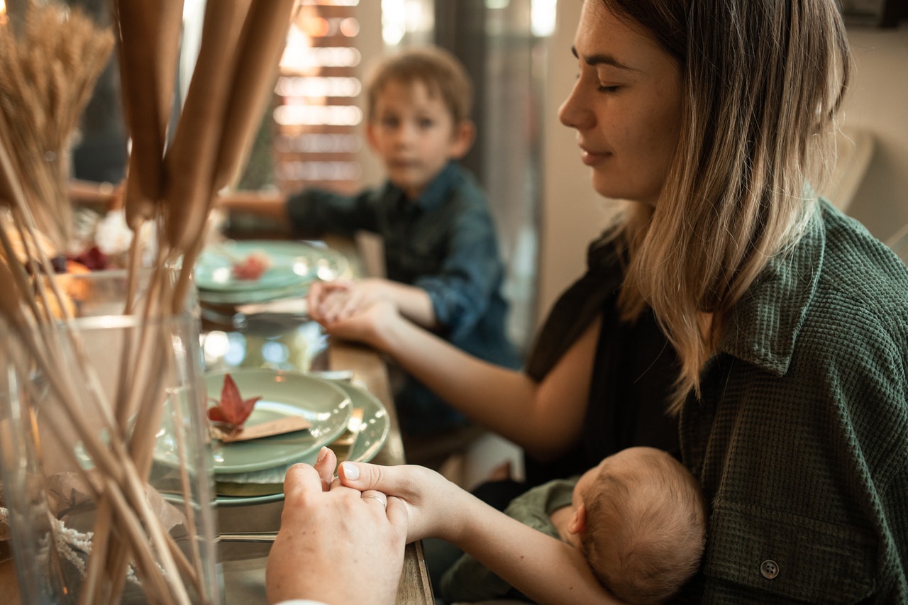 Fun - Woman holding baby at dinner table