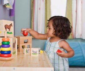 Child playing with blocks and wood toys