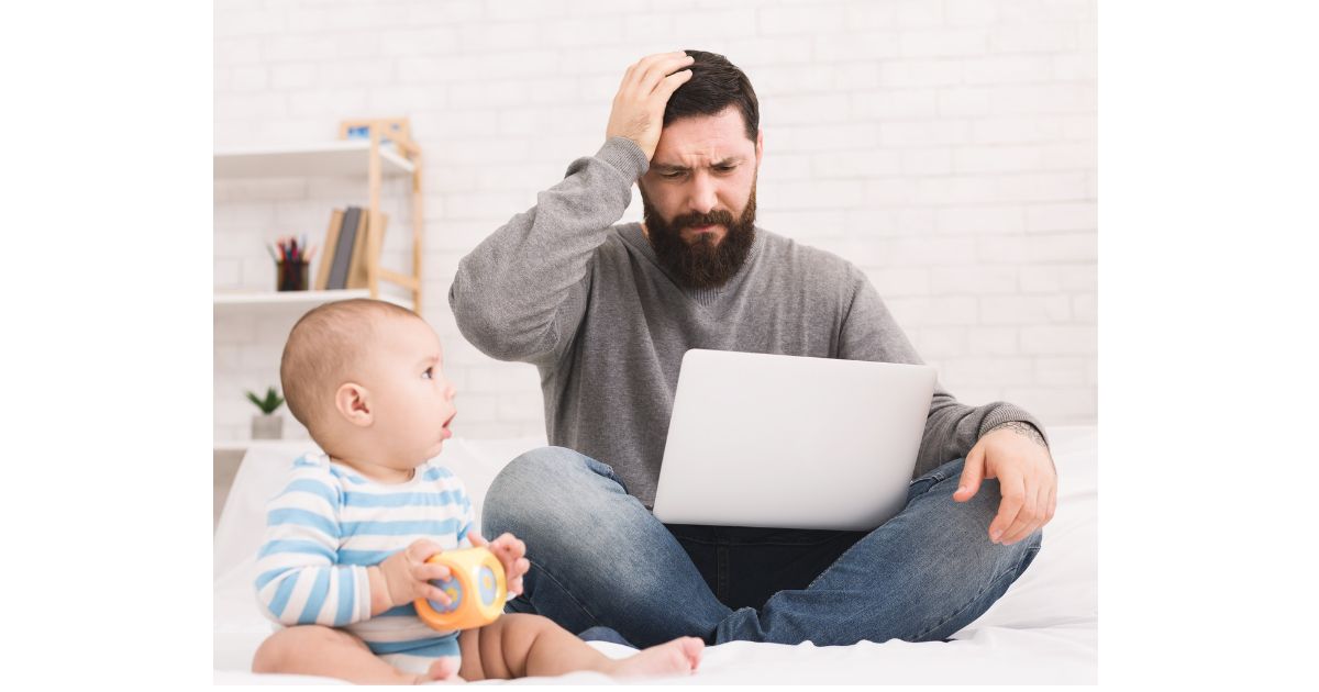 wake windows: a dad and a baby sitting on the floor - the dad looks confused while looking at a laptop