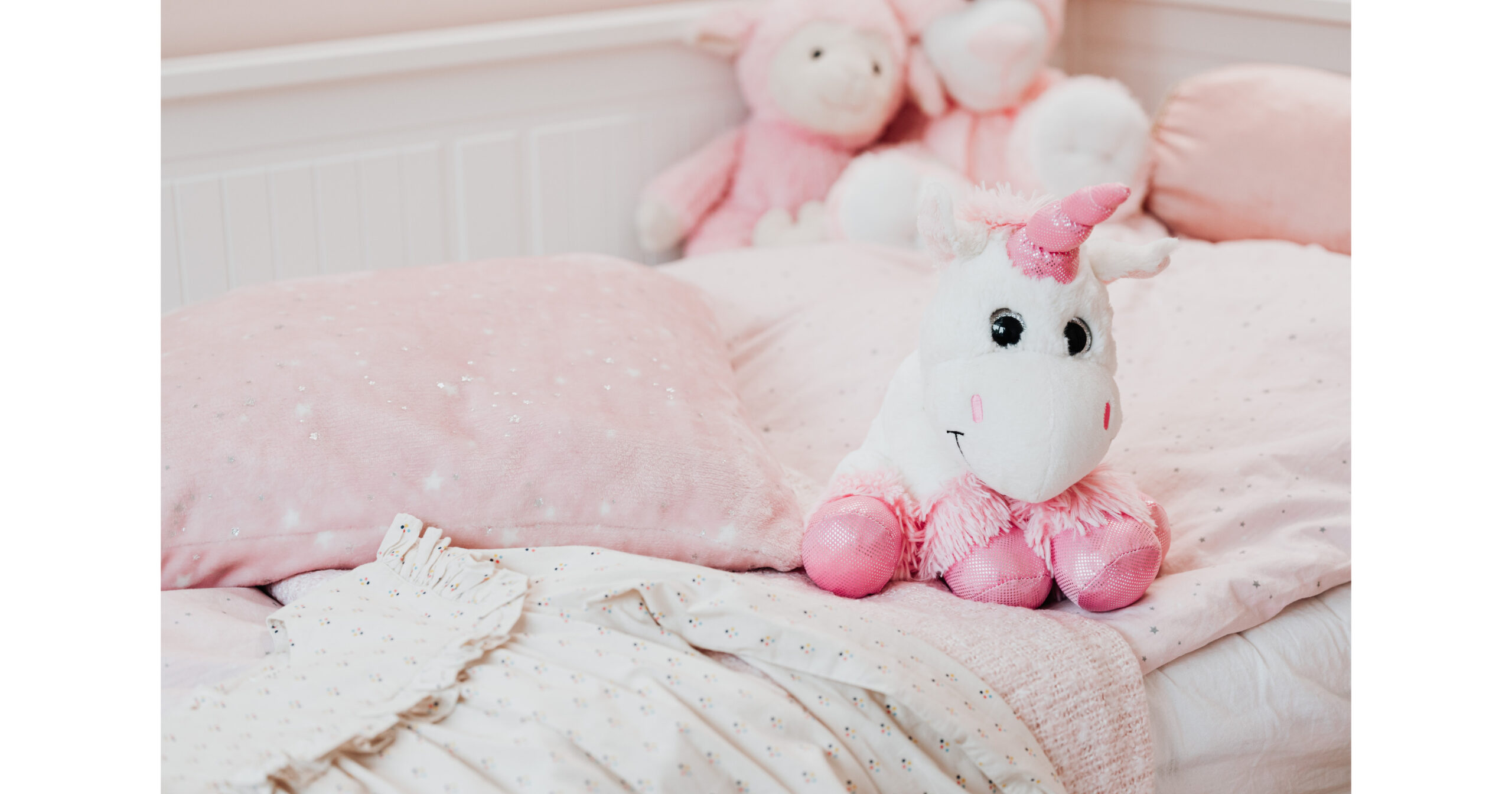 child’s pink bedding with stuffed unicorn - baby gifts